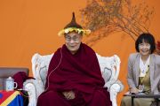 По завершении лекции Его Святейшество Далай-лама примеряет подаренную ему одним из слушателей вязаную шапочку в форме подсолнуха. Токио, Япония. 17 ноября 2018 г. Фото: Тензин Чойджор.